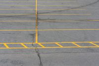 an empty parking lot with several lines painted on it in yellow and black colors as shown from above