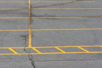 an empty parking lot with several lines painted on it in yellow and black colors as shown from above