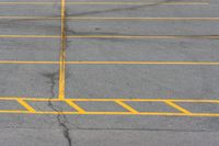 an empty parking lot with several lines painted on it in yellow and black colors as shown from above