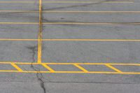 an empty parking lot with several lines painted on it in yellow and black colors as shown from above