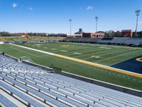 a stadium that has bleachers and seats on the side of the field and in front of the stands