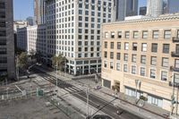 a parking lot has two parking meter and two red telephone booths in it, the city behind it