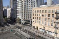 a parking lot has two parking meter and two red telephone booths in it, the city behind it