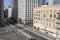 a parking lot has two parking meter and two red telephone booths in it, the city behind it