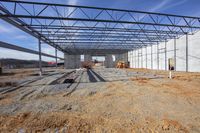 workers work inside a steel structure on a construction site in a rural area under construction