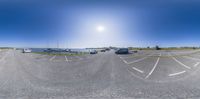 this is an image of a large parking lot with rvs in it and a yacht club in the distance