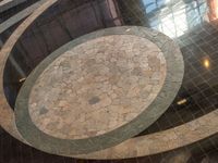 an empty floor with the marble patterns being laid on top of it is reflected in a shiny window