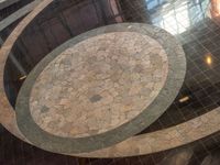 an empty floor with the marble patterns being laid on top of it is reflected in a shiny window