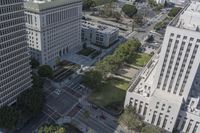 the view from the top of the building shows traffic driving down a city street and other buildings