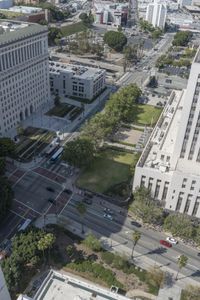 the view from the top of the building shows traffic driving down a city street and other buildings