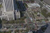 the view from the top of the building shows traffic driving down a city street and other buildings