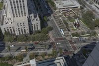the view from the top of the building shows traffic driving down a city street and other buildings