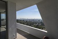 the view of a city outside from inside a home with large windows, outside, and city skyline, through the panoramic glass window