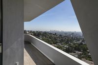 the view of a city outside from inside a home with large windows, outside, and city skyline, through the panoramic glass window