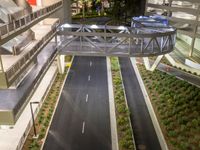 a view of a road and an overpass with traffic passing through it by buildings