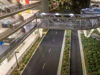 a view of a road and an overpass with traffic passing through it by buildings