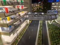 a view of a road and an overpass with traffic passing through it by buildings