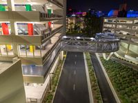 a view of a road and an overpass with traffic passing through it by buildings