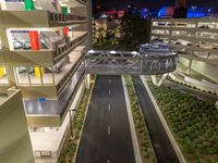 a view of a road and an overpass with traffic passing through it by buildings