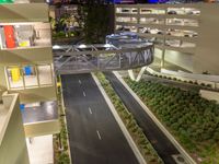 a view of a road and an overpass with traffic passing through it by buildings