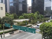 this city is looking over the intersection of a street sign and a bridge that leads to it