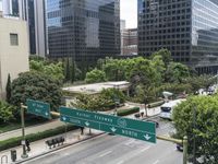 this city is looking over the intersection of a street sign and a bridge that leads to it