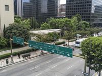 this city is looking over the intersection of a street sign and a bridge that leads to it