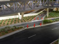 a view of a road and an overpass with traffic passing through it by buildings