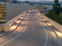 a view of a road and an overpass with traffic passing through it by buildings