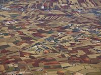 aerial view of the country with fields and fields surrounding a valley in the middle of nowhere