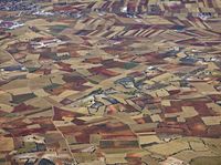 aerial view of the country with fields and fields surrounding a valley in the middle of nowhere