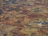 aerial view of the country with fields and fields surrounding a valley in the middle of nowhere