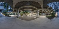 a large white building with many stairs and curved concrete pillars in it, there is a lot of stairs in the background