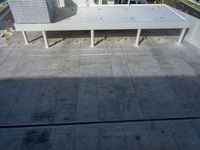 a street view of the buildings and the water from an apartment block's balcony