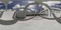 a wide angle view from an inside perspective of a building, through a circular object, to an outside circle