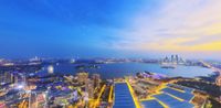 a view of city skyline from the top of the building in a blue sky and purple clouds