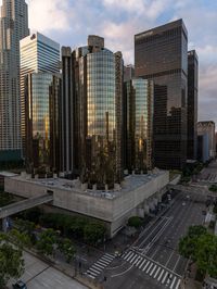 an aerial view of tall buildings in the city of los at sunrise, with traffic and cars traveling through the intersection