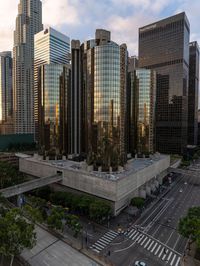 an aerial view of tall buildings in the city of los at sunrise, with traffic and cars traveling through the intersection