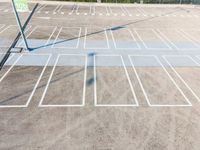 a parking lot with a tennis racket and rackets in the sand and the sun on top