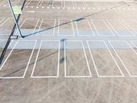 a parking lot with a tennis racket and rackets in the sand and the sun on top