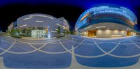 an aerial view of an entrance to a modern building at night with lensing out the reflection