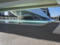 a view of the structure of a modern city, which contains a fountain and buildings