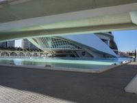 a view of the structure of a modern city, which contains a fountain and buildings