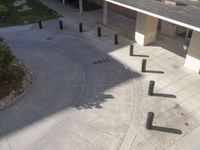 an empty parking lot surrounded by trees and concrete floors with multiple posts with letters in them