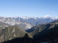 the view of mountains from the top of a mountain with cable car tracks and cable