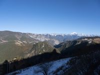 the view of mountains from the top of a mountain with cable car tracks and cable