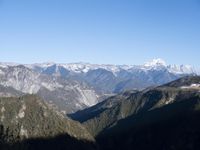 the view of mountains from the top of a mountain with cable car tracks and cable