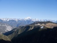 the view of mountains from the top of a mountain with cable car tracks and cable