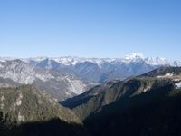 the view of mountains from the top of a mountain with cable car tracks and cable