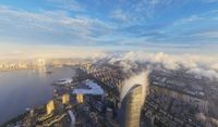 foggy city and river near a waterway as seen from a bird - eye view